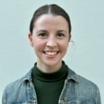 Merryn G, A Woman Wearing A Denim Jacket And Green Shirt.